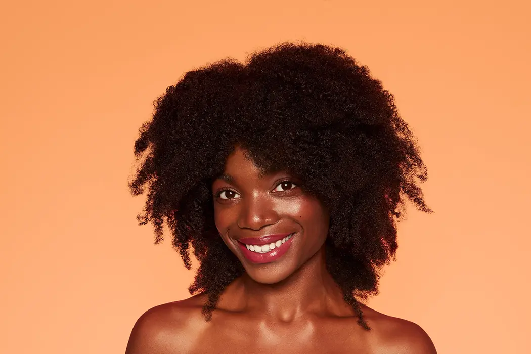 smiling black woman with natural afro curls