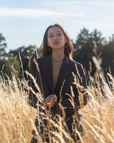 Woman in a suit standing in a field